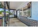 Inviting covered porch with black brick accents and decorative shutters enhance the curb appeal at 7507 Duo Lakes Dr, Orlando, FL 32810