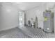 Utility room with patterned tile floor, white walls and a water heater at 7507 Duo Lakes Dr, Orlando, FL 32810