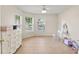 Neutral bedroom with tiled floors and large windows bringing in tons of natural light at 802 Pickfair Ter, Lake Mary, FL 32746