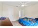 Bedroom featuring a blue themed bedspread, ceiling fan, and a large dresser at 802 Pickfair Ter, Lake Mary, FL 32746