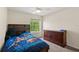 Cozy bedroom featuring a dark wood dresser, blue themed bedspread, and natural light from the window at 802 Pickfair Ter, Lake Mary, FL 32746