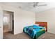 Cozy bedroom with a ceiling fan and a view of the tiled bathroom at 802 Pickfair Ter, Lake Mary, FL 32746
