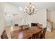 Dining room featuring tiled floors and an elegant chandelier over a wooden dining table at 802 Pickfair Ter, Lake Mary, FL 32746