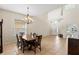 Dining room featuring tiled floors and an elegant chandelier over a wooden dining table at 802 Pickfair Ter, Lake Mary, FL 32746
