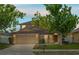 Two-story home featuring a well-manicured lawn, mature shade trees, and attached two-car garage at 802 Pickfair Ter, Lake Mary, FL 32746