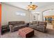 Bright open living room features ceiling fan and leads to the kitchen at 802 Pickfair Ter, Lake Mary, FL 32746