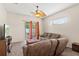 Bright living room features fan, sliding glass doors with access to the patio at 802 Pickfair Ter, Lake Mary, FL 32746
