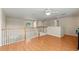 Spacious loft with hardwood floors, white railings and staircase, and neutral paint, perfect for relaxation and entertainment at 802 Pickfair Ter, Lake Mary, FL 32746