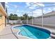 Backyard pool with a screened enclosure and inviting blue tile accents at 802 Pickfair Ter, Lake Mary, FL 32746