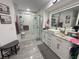 This bathroom boasts an updated glass shower, vanity, and neutral gray floors at 8398 Split Creek Cir, Lakeland, FL 33809
