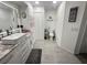 Charming bathroom features updated vanity with granite counters and tiled floors at 8398 Split Creek Cir, Lakeland, FL 33809