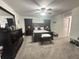 Cozy bedroom featuring a ceiling fan, carpeted floors, dark furniture, and subtle decorations at 8398 Split Creek Cir, Lakeland, FL 33809