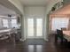 Open foyer with wood floors leading to a dining room and kitchen, providing a spacious and welcoming atmosphere at 8398 Split Creek Cir, Lakeland, FL 33809