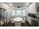 Eat-in kitchen with white cabinets, stainless steel appliances and bay window that provides ample natural light at 8398 Split Creek Cir, Lakeland, FL 33809