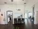 Open-concept living room with modern furniture, dark floors, and views into the kitchen and foyer at 8398 Split Creek Cir, Lakeland, FL 33809