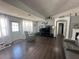 Inviting living room with dark wood floors, a large television, and comfortable seating at 8398 Split Creek Cir, Lakeland, FL 33809