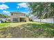 Large backyard featuring lush lawn space and a covered patio, creating a perfect outdoor oasis for relaxation and entertainment at 8448 Greenbank Blvd, Windermere, FL 34786
