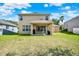 A spacious backyard features an expansive green lawn, with an outdoor patio at 8448 Greenbank Blvd, Windermere, FL 34786