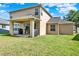 Backyard featuring a covered patio, sliding glass doors, well-maintained lawn, and a spacious outdoor living area at 8448 Greenbank Blvd, Windermere, FL 34786