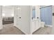 This bathroom features vinyl floors, a single vanity sink, and a shower with a blue patterned curtain at 8448 Greenbank Blvd, Windermere, FL 34786