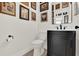 Half-bathroom featuring a modern black vanity, stylish decor and fixtures at 8448 Greenbank Blvd, Windermere, FL 34786