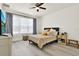 Bright bedroom with a ceiling fan, large window, and neutral decor at 8448 Greenbank Blvd, Windermere, FL 34786