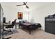 Bedroom features a ceiling fan, large window with blinds, and a comfortable bed with a nearby desk at 8448 Greenbank Blvd, Windermere, FL 34786