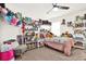 Cozy bedroom featuring plush carpeting, a ceiling fan, and charming shelves filled with delightful collectibles at 8448 Greenbank Blvd, Windermere, FL 34786