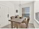 Bright dining area with a modern pendant light fixture and a window at 8448 Greenbank Blvd, Windermere, FL 34786