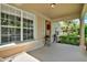 Welcoming front porch featuring decorative plants, a wreath, and natural light at 8448 Greenbank Blvd, Windermere, FL 34786