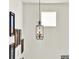 Unique hallway with ornate lighting fixture and decorative framed art for visual interest at 8448 Greenbank Blvd, Windermere, FL 34786