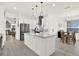 Bright open concept kitchen with stainless steel appliances and seating at the island at 8448 Greenbank Blvd, Windermere, FL 34786