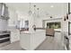 Open kitchen and dining area with stainless appliances and island seating at 8448 Greenbank Blvd, Windermere, FL 34786