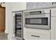 A modern kitchen boasts stainless steel appliances including a wine fridge and built-in microwave at 8448 Greenbank Blvd, Windermere, FL 34786
