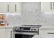 Close up of kitchen stove and backsplash at 8448 Greenbank Blvd, Windermere, FL 34786