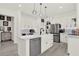 Modern kitchen with a large island, stainless steel appliances, and stylish pendant lighting at 8448 Greenbank Blvd, Windermere, FL 34786