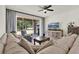 Comfortable living room with sliding glass doors to the outdoors and a ceiling fan at 8448 Greenbank Blvd, Windermere, FL 34786