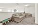 Cozy upstairs living room featuring neutral walls, plush carpet, and comfortable seating with charming decor at 8448 Greenbank Blvd, Windermere, FL 34786