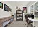 Well-lit home office space, decorated with artwork and shelving at 8448 Greenbank Blvd, Windermere, FL 34786