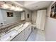 Bright bathroom featuring a double sink vanity with granite countertop, a bathtub and shower combo, and tile flooring at 8484 Sandberry Blvd, Orlando, FL 32819