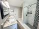 Modern bathroom features double vanity and walk-in shower with decorative tile accent at 8484 Sandberry Blvd, Orlando, FL 32819