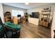 Well-lit bedroom with a modern desk, wooden floors, large window, and decor shelving for ample storage space at 8484 Sandberry Blvd, Orlando, FL 32819