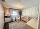 Cozy Bedroom features a crib, rocking chair, and modern chandelier at 8484 Sandberry Blvd, Orlando, FL 32819