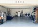 Spacious two-car garage with epoxy flooring, ample storage, and laundry area with washer and dryer at 8484 Sandberry Blvd, Orlando, FL 32819