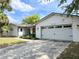 Two-car garage with attached living space and manicured landscaping at 8484 Sandberry Blvd, Orlando, FL 32819