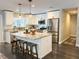 Updated kitchen with center island, white cabinetry and stainless appliances at 8484 Sandberry Blvd, Orlando, FL 32819