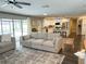 Open concept living room flows into kitchen and features sliding doors at 8484 Sandberry Blvd, Orlando, FL 32819