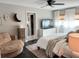Comfortable main bedroom showcasing a cozy armchair, tv and dresser at 8484 Sandberry Blvd, Orlando, FL 32819