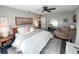 Calming main bedroom features a plush armchair and an arched mirror at 8484 Sandberry Blvd, Orlando, FL 32819