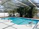 Sparkling pool surrounded by lush landscaping and a screened enclosure for privacy and enjoyment at 8484 Sandberry Blvd, Orlando, FL 32819